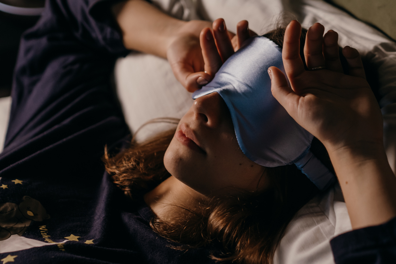 A Woman Wearing a Sleep Mask